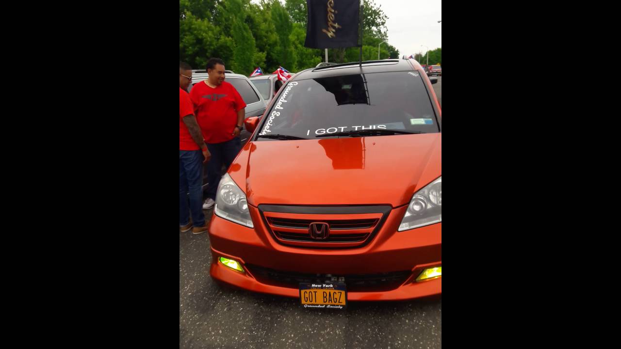 Orange Honda Odyssey at a street gathering