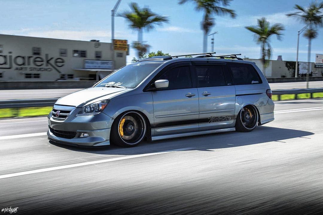 Silver Honda Odyssey with VanKulture decal, lowered, rolling shot